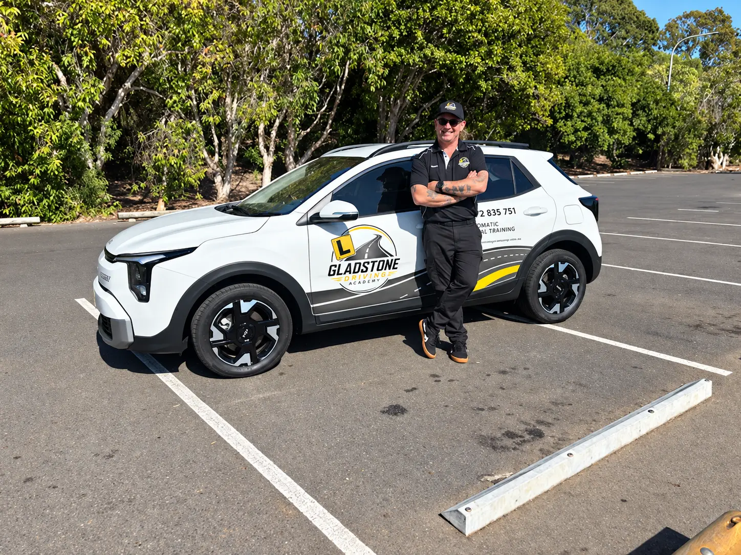 Simon standing beside the Gladstone Driving Academy training car